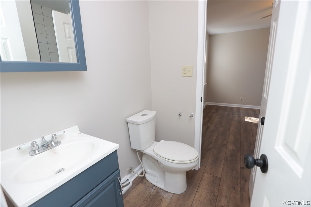 1355 Robindale Road Richmond, VA 23235 - Photo 14 of 35 a white toilet sitting next to a bathroom sink