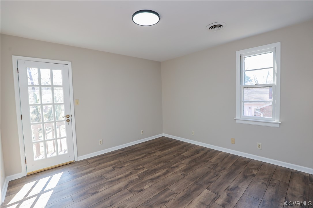 1355 Robindale Road Richmond, VA 23235 - Photo 22 of 35 an empty room with wooden floor and windows