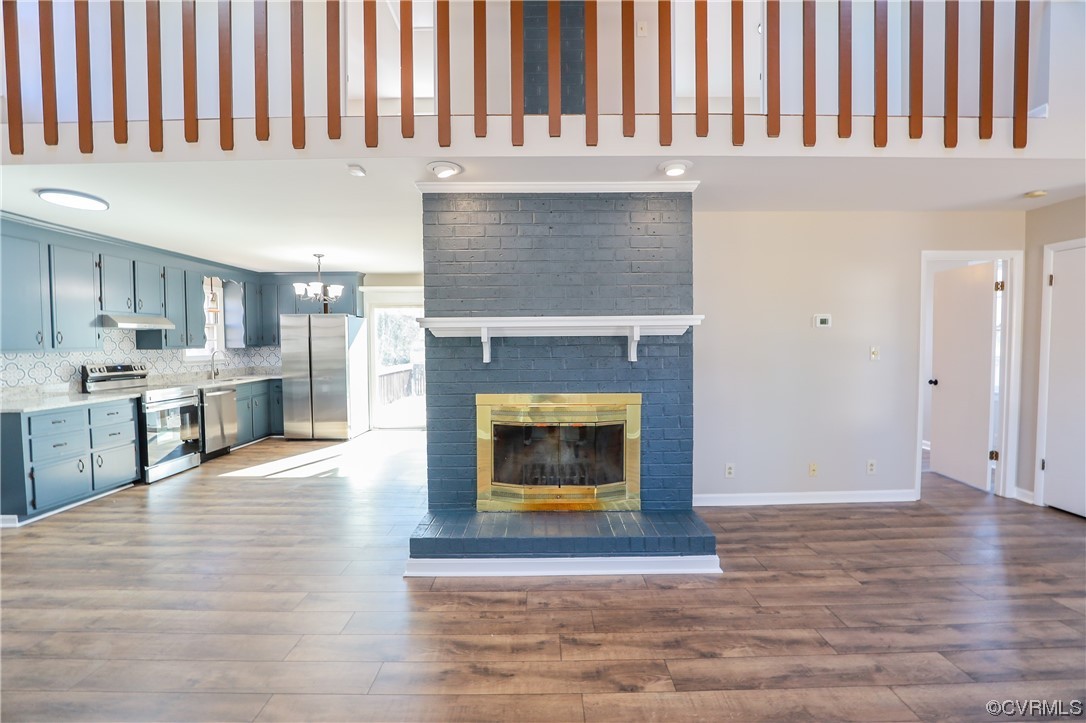 1355 Robindale Road Richmond, VA 23235 - Photo 5 of 35 a living room with stainless steel appliances granite countertop a fireplace a stove and a refrigerator