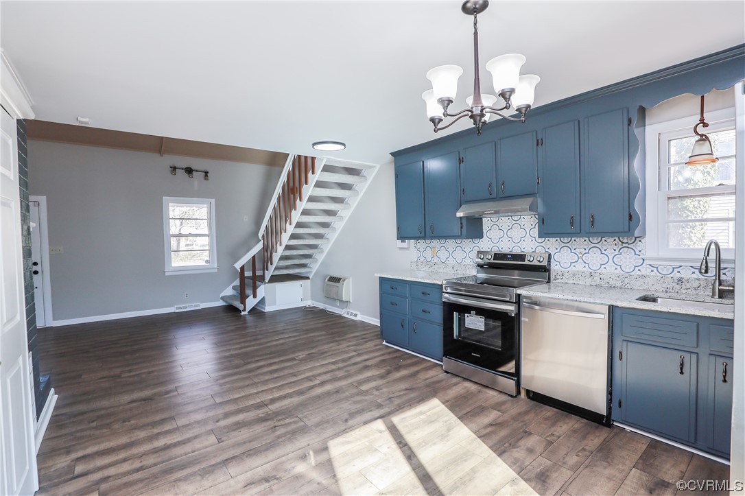 1355 Robindale Road Richmond, VA 23235 - Photo 7 of 35 a kitchen with kitchen island granite countertop a sink stainless steel appliances cabinets and a window
