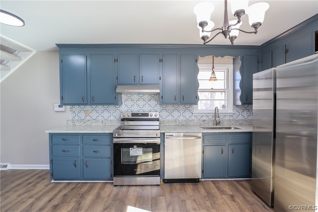 1355 Robindale Road Richmond, VA 23235 - Photo 8 of 35 a kitchen with kitchen island granite countertop a sink cabinets a window and stainless steel appliances