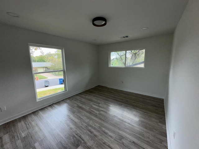 2101 Vanderbilt Lane Austin, TX 78723 - Photo 10 of 11 Spare room with dark wood-style floors and baseboards