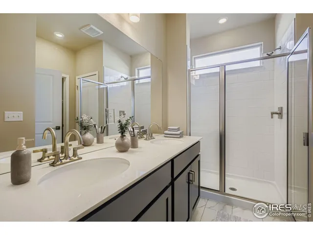 a bathroom with a sink double vanity and a mirror