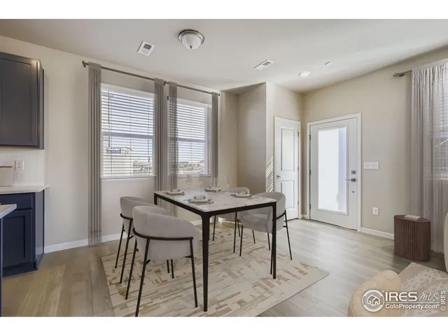 a view of a room with furniture and wooden floor
