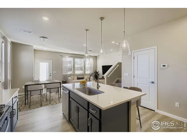 a kitchen with kitchen island sink stove and dining table