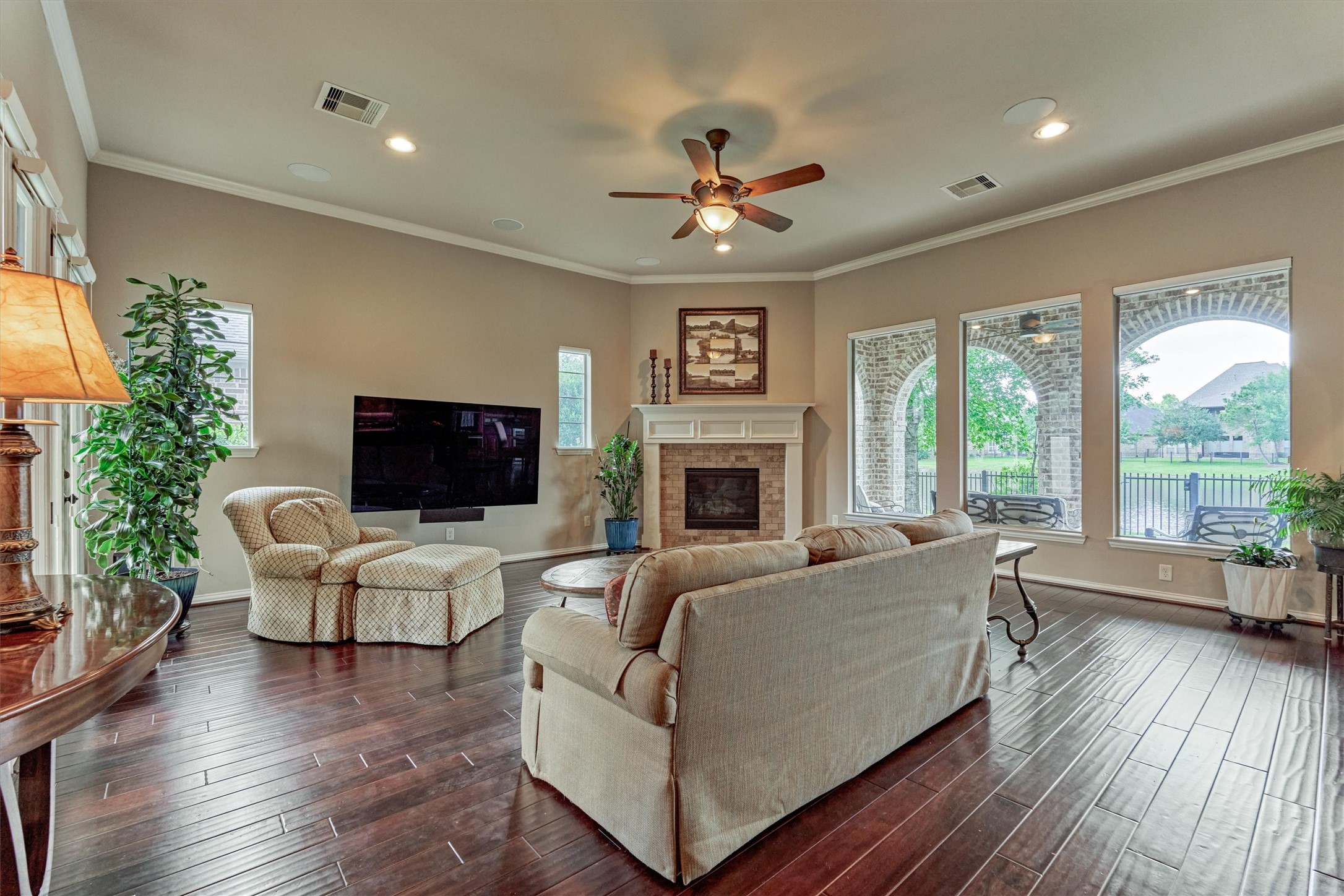82 East Crystal Canyon Circle The Woodlands, TX 77389 - Photo 8 of 50 Bathed in natural light, this great room exudes elegance and comfort, with dreamy waterfront views showcased through expansive windows.