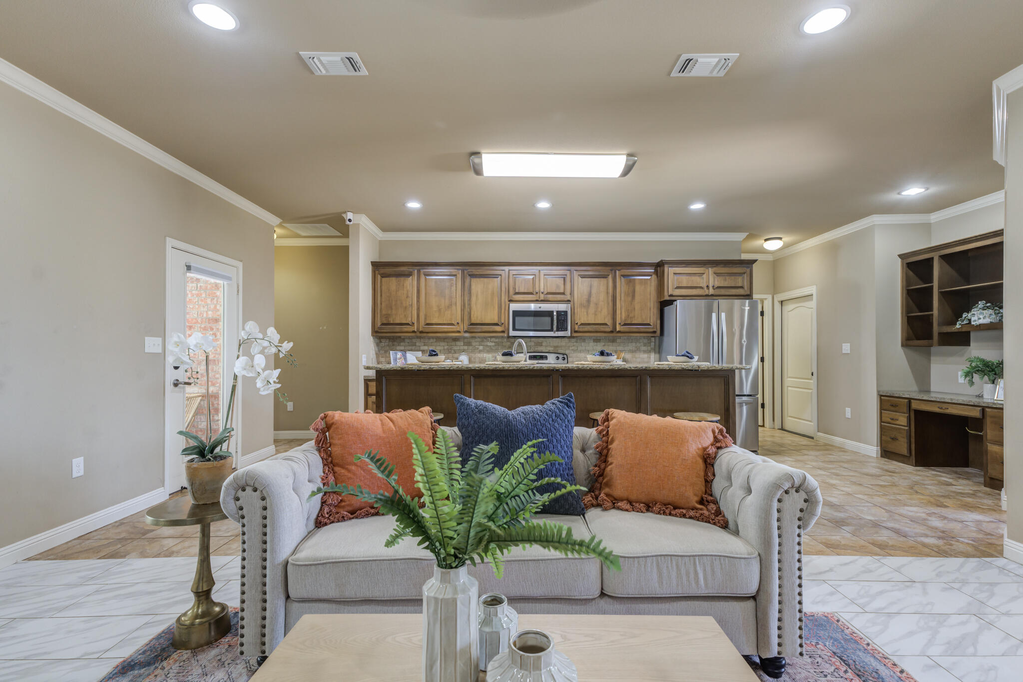 6512 71st Street Lubbock, TX 79424 - Photo 11 of 41 a living room with furniture potted plant and kitchen view