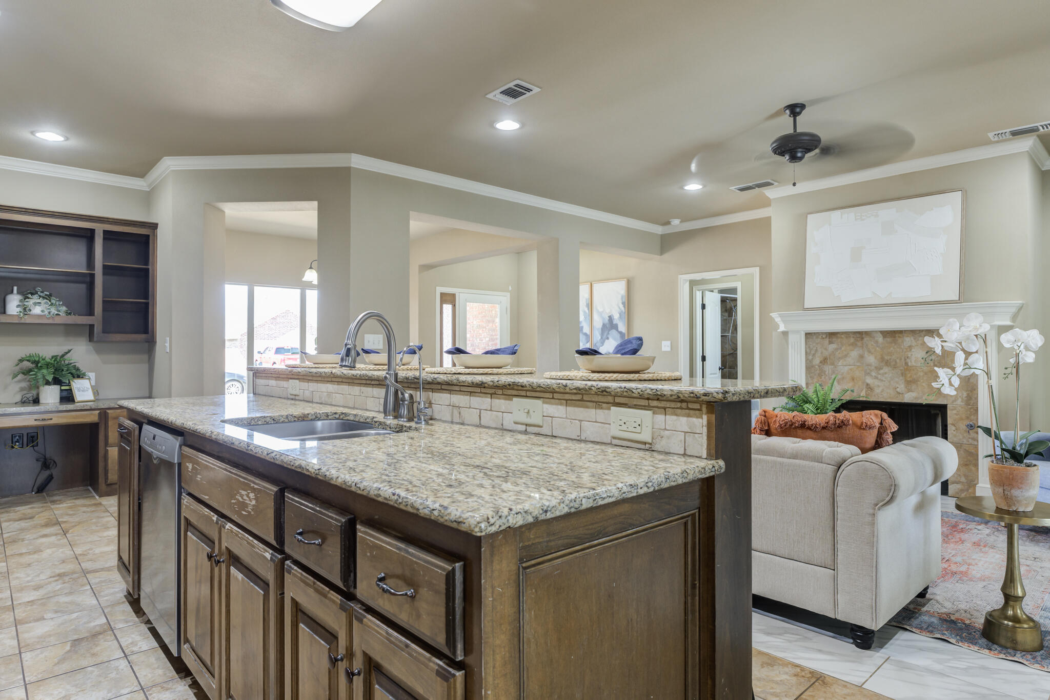 6512 71st Street Lubbock, TX 79424 - Photo 15 of 41 a view of living room with granite countertop furniture and fireplace