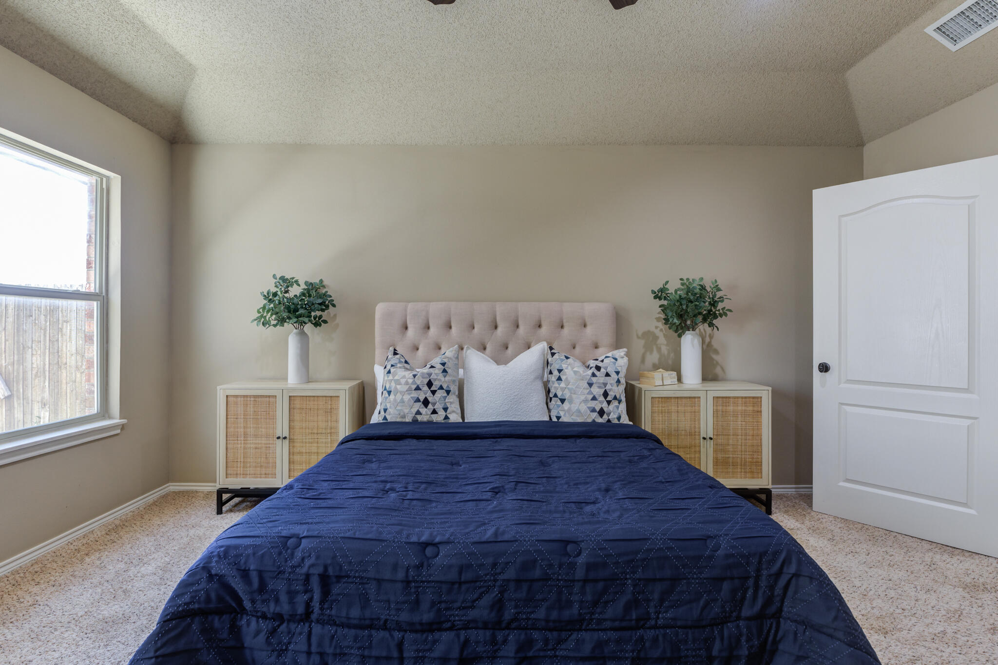 6512 71st Street Lubbock, TX 79424 - Photo 22 of 41 a bed sitting in a bedroom next to a window