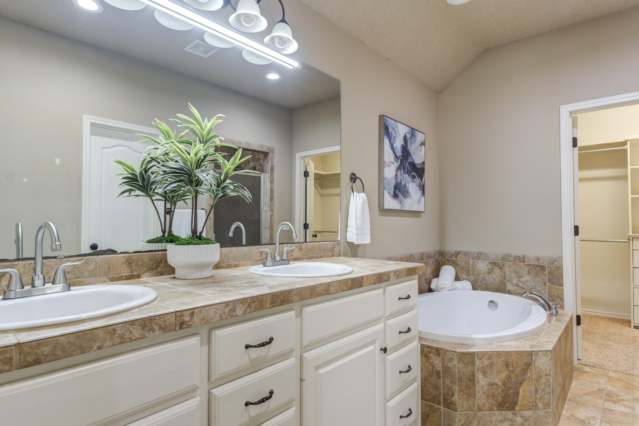 6512 71st Street Lubbock, TX 79424 - Photo 25 of 41 a bathroom with a granite countertop sink mirror and vanity