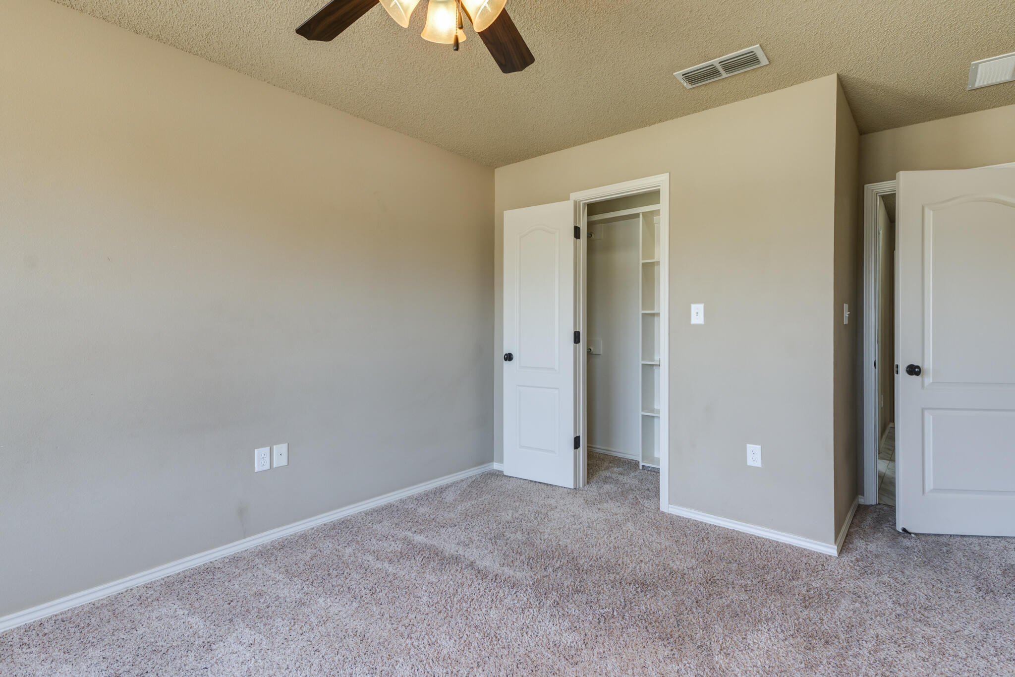 6512 71st Street Lubbock, TX 79424 - Photo 30 of 41 en empty room with closet and a chandelier fan
