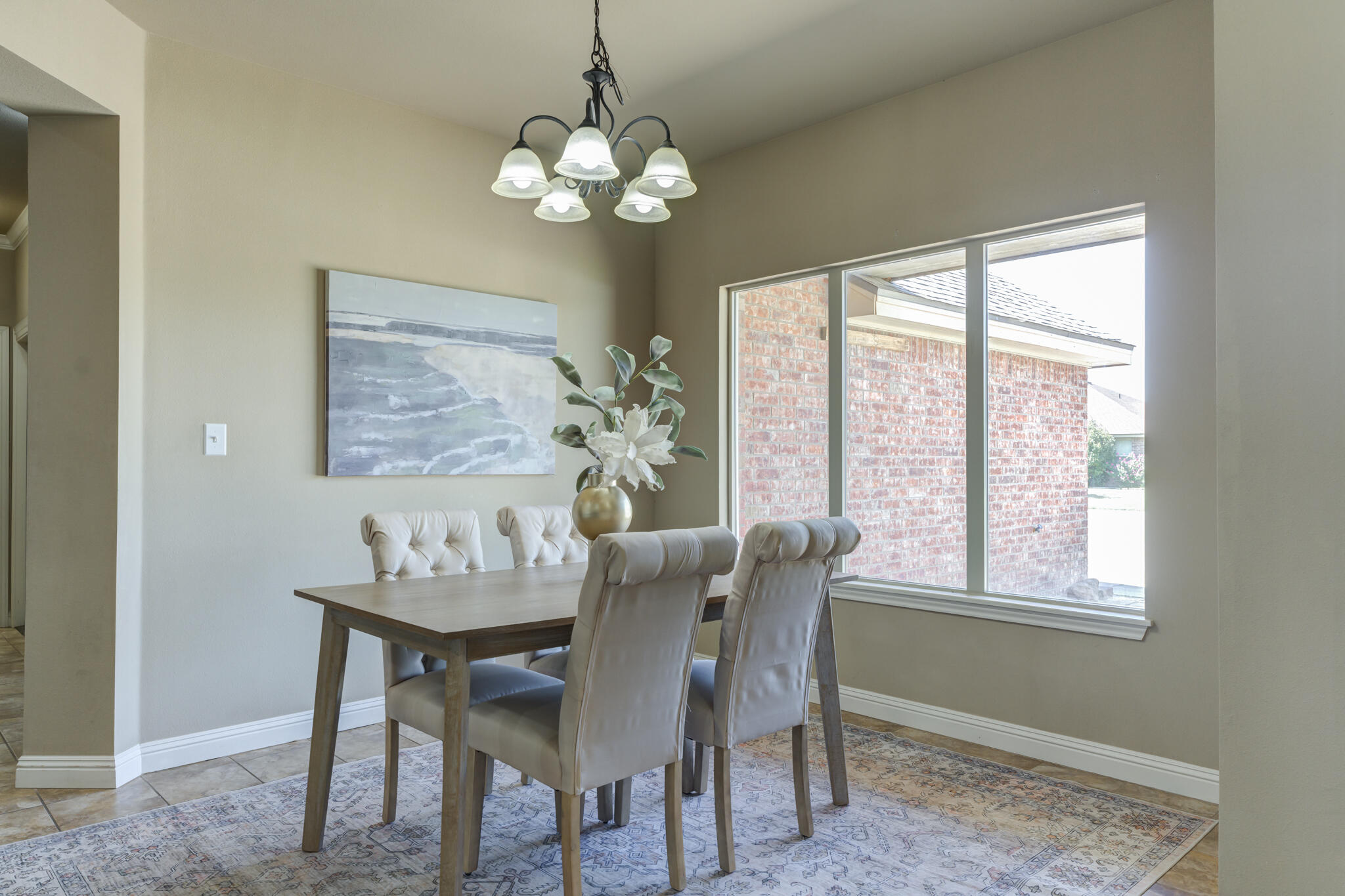 6512 71st Street Lubbock, TX 79424 - Photo 3 of 41 a dining room with furniture a rug and a chandelier