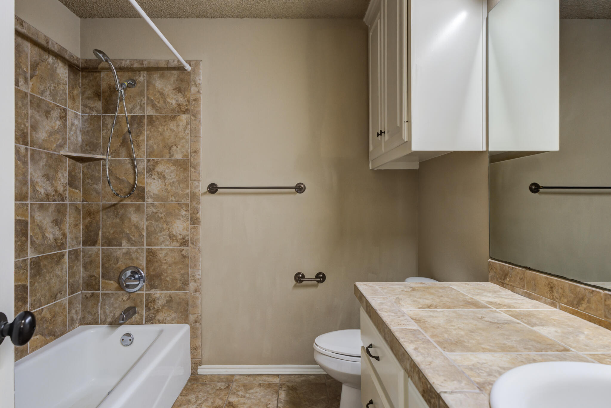 6512 71st Street Lubbock, TX 79424 - Photo 32 of 41 a bathroom with a granite countertop sink toilet and shower