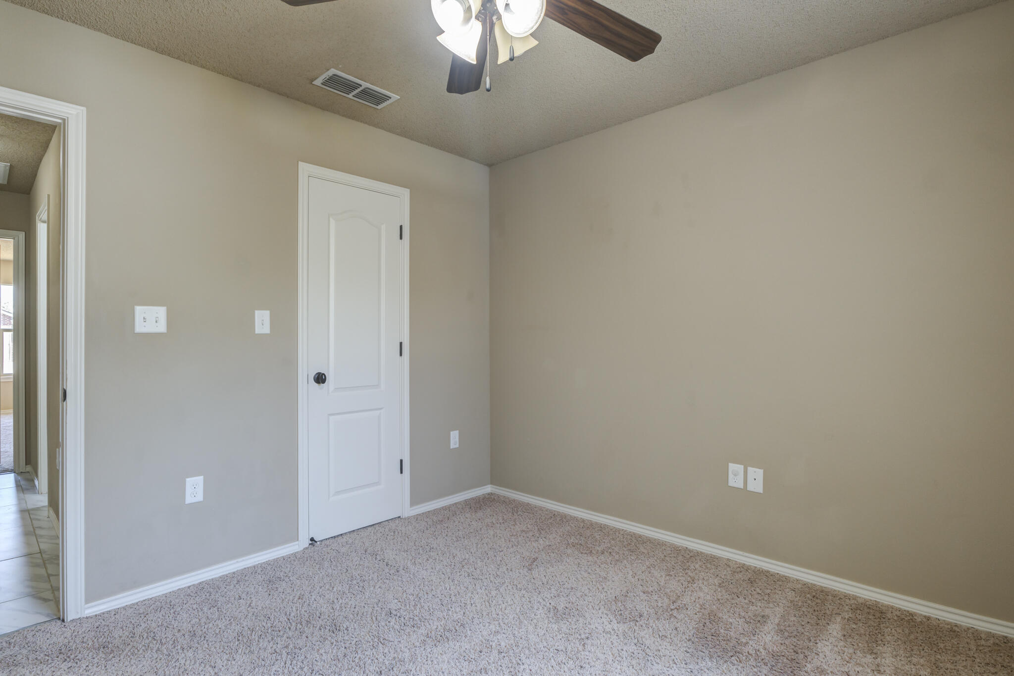 6512 71st Street Lubbock, TX 79424 - Photo 34 of 41 an empty room with a chandelier fan