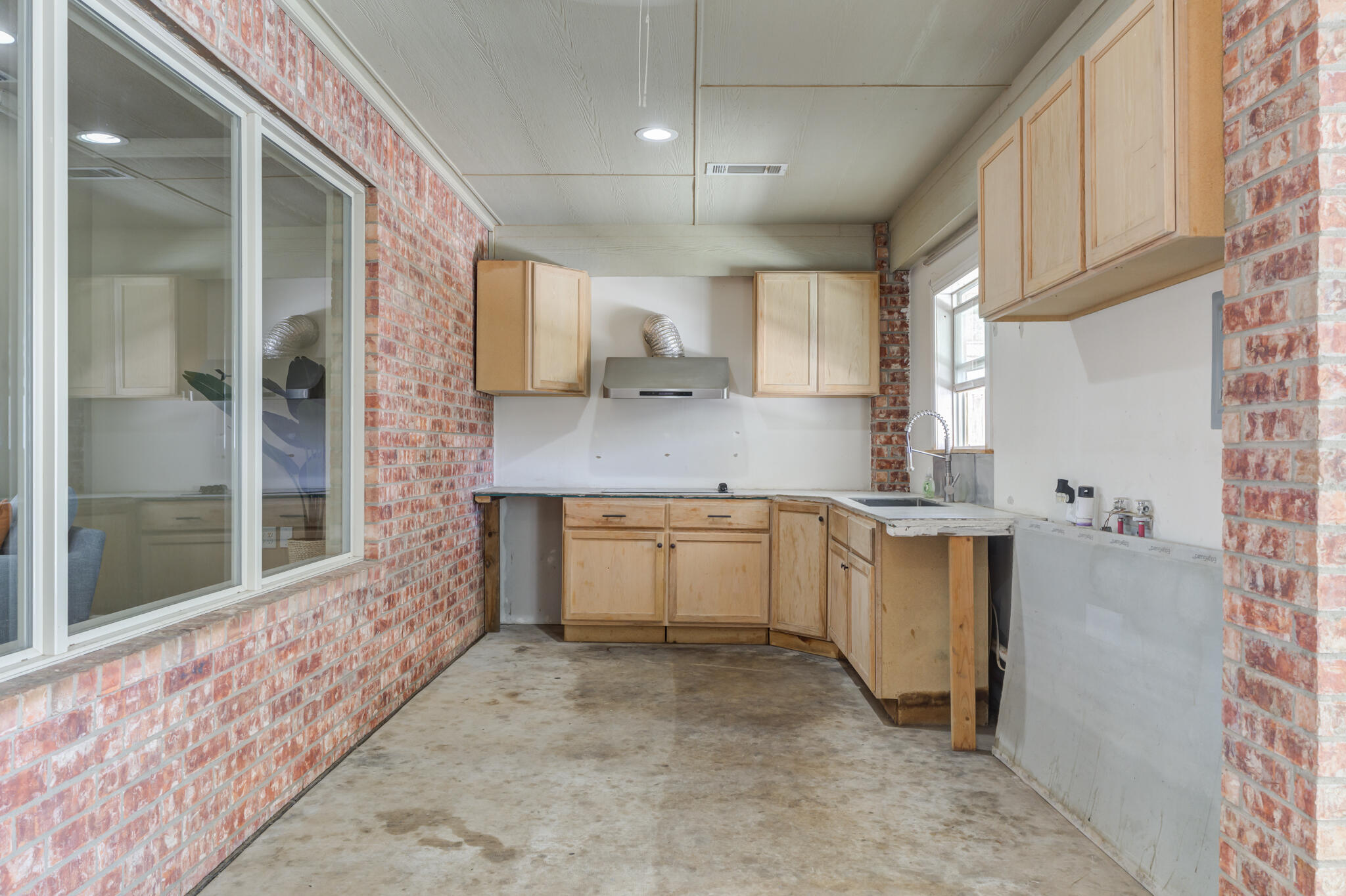 6512 71st Street Lubbock, TX 79424 - Photo 35 of 41 a kitchen with granite countertop a sink and cabinets