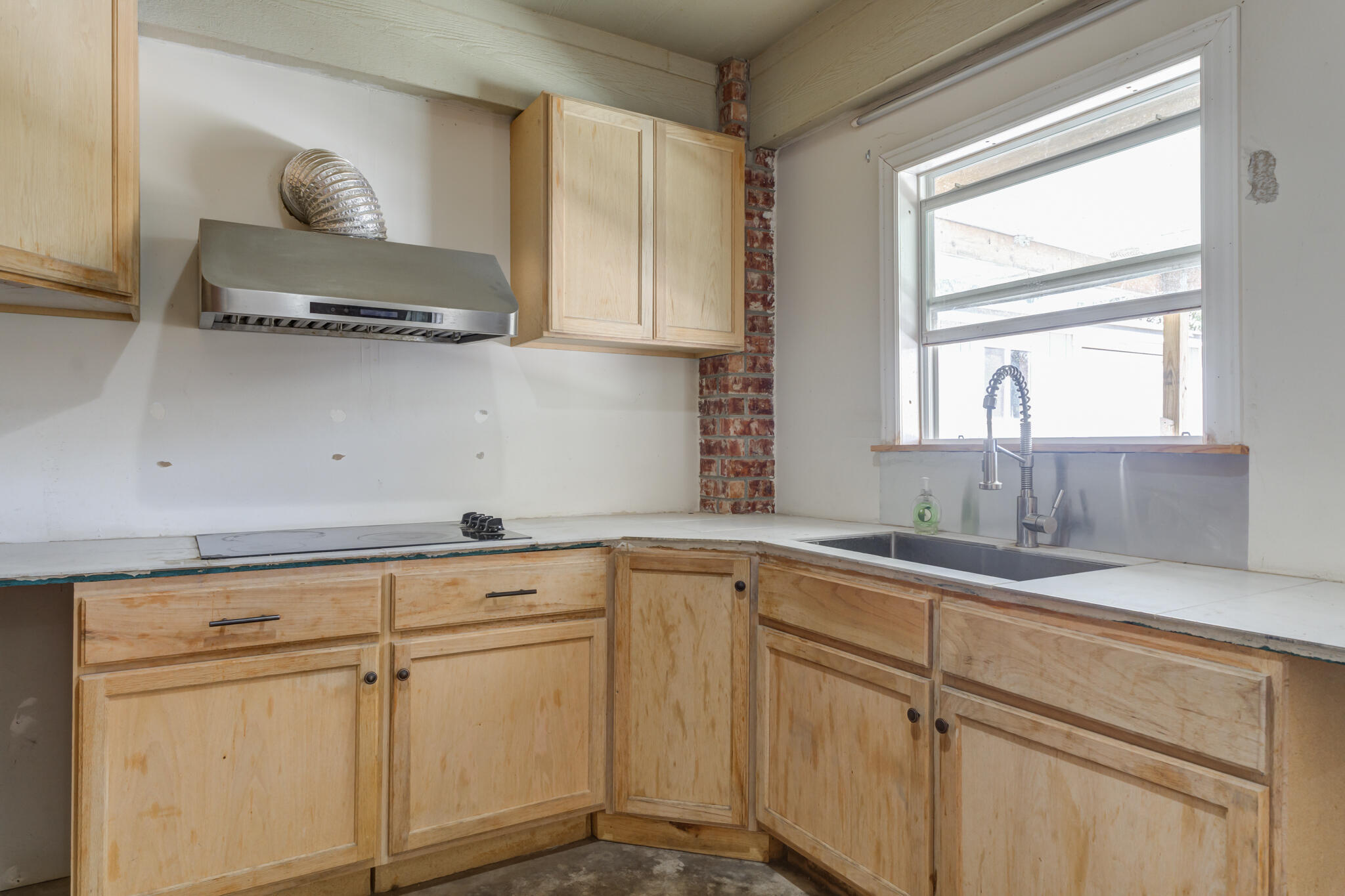 6512 71st Street Lubbock, TX 79424 - Photo 36 of 41 a kitchen with white cabinets and window
