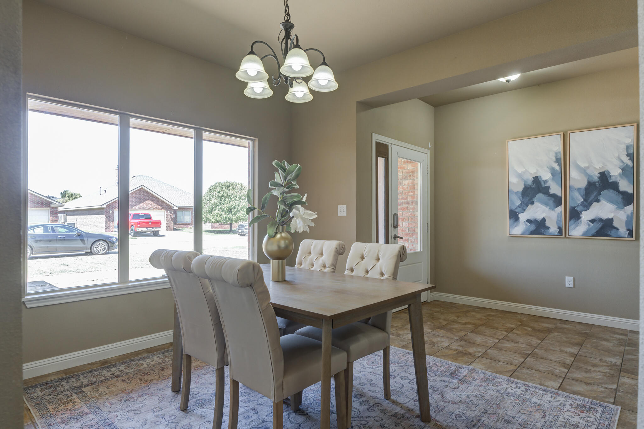 6512 71st Street Lubbock, TX 79424 - Photo 5 of 41 a view of a dining room with furniture wooden floor and chandelier