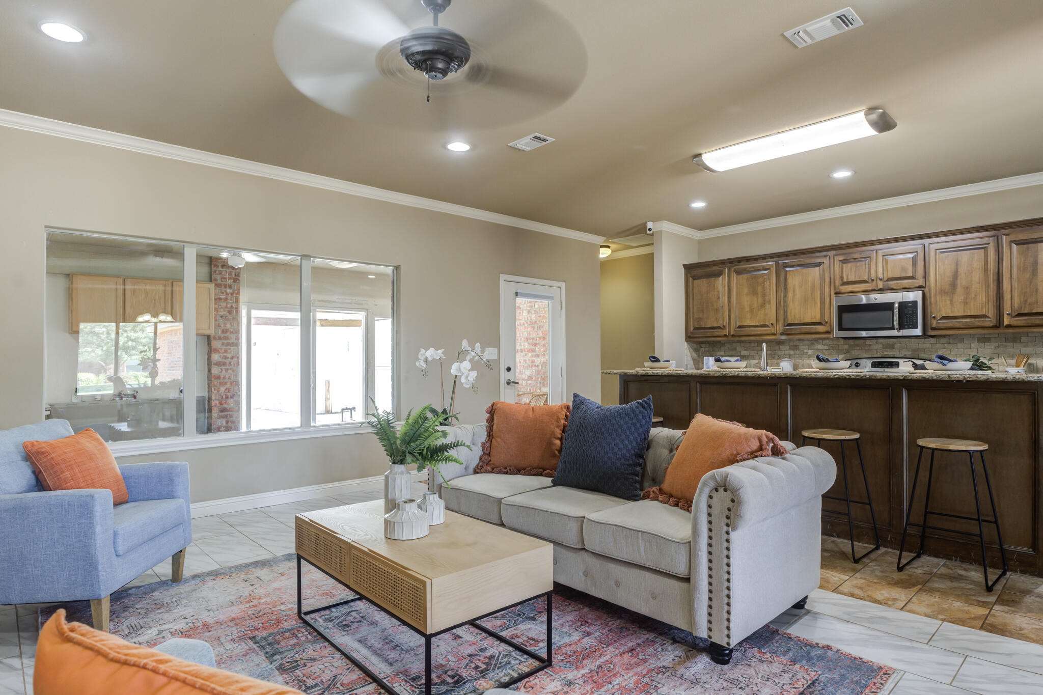 6512 71st Street Lubbock, TX 79424 - Photo 7 of 41 a living room with furniture kitchen view and a large window