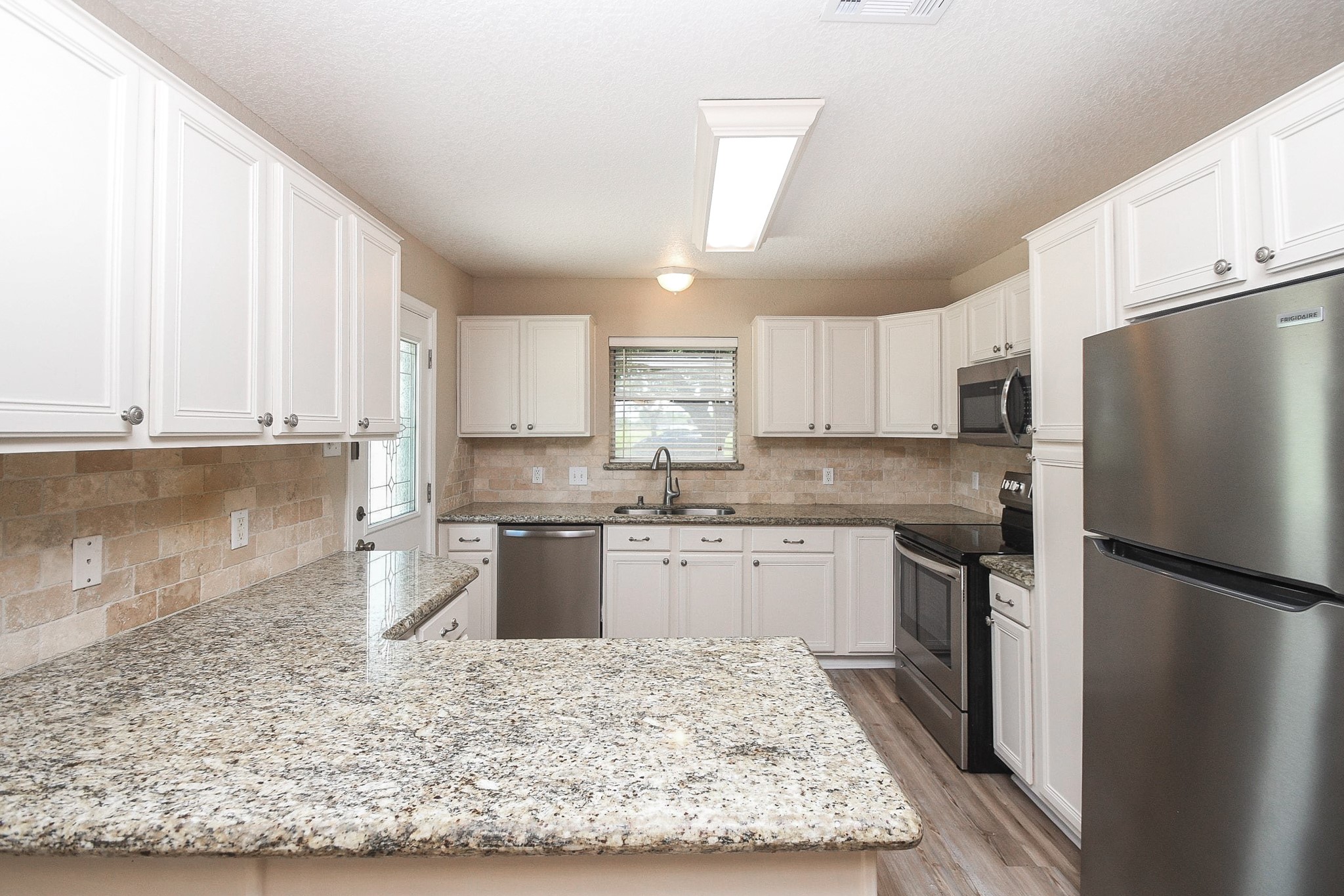 16902 Berry Road Pearland, TX 77584 - Photo 3 of 30 Updated kitchen with granite counters