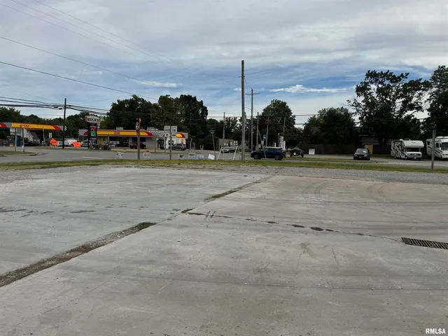 a view of a yard with cars parked
