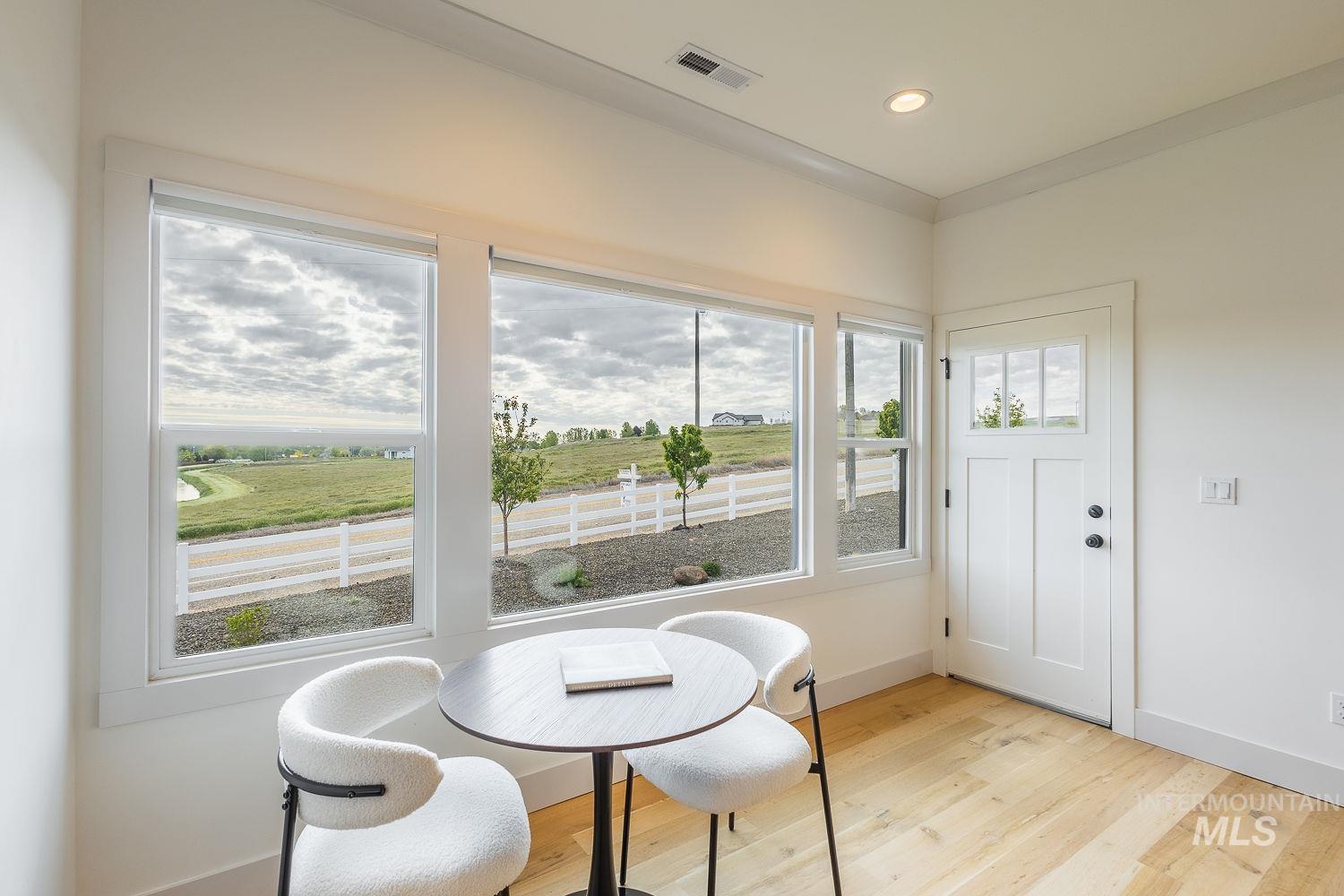 11171 Pump Road Nampa, ID 83686 - Photo 14 of 50 Bright interior space with light wood-finish flooring, white walls, and white trim