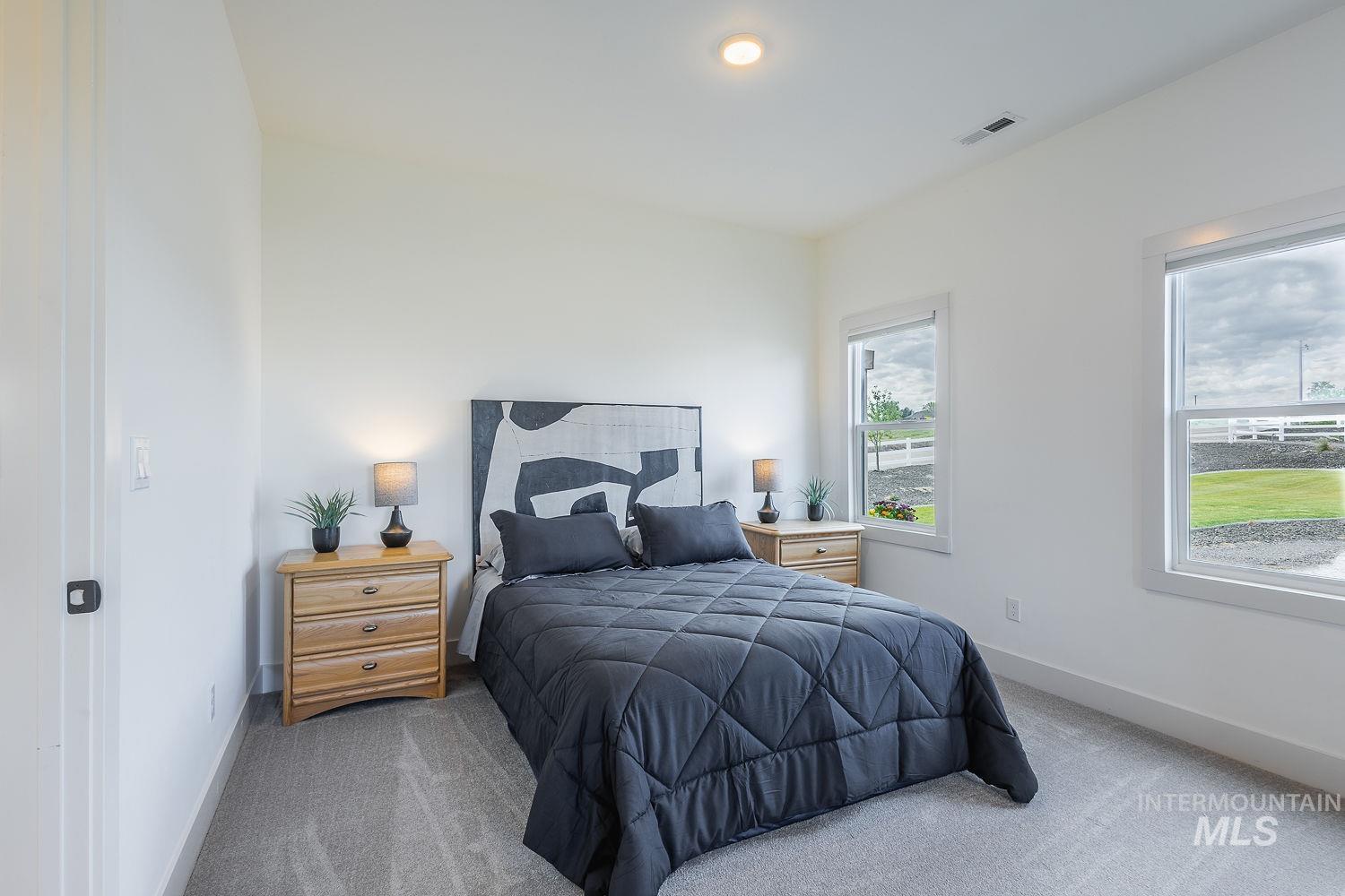 11171 Pump Road Nampa, ID 83686 - Photo 18 of 50 Bright bedroom featuring two windows, recessed lighting, and light gray carpeting