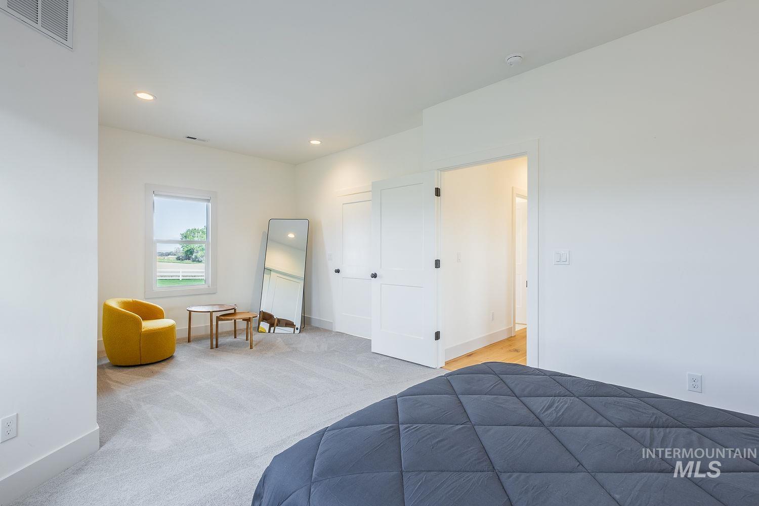 11171 Pump Road Nampa, ID 83686 - Photo 19 of 50 Spacious room featuring light gray carpeting, recessed ceiling lighting, a white trim window, and white panel doors with black hardware