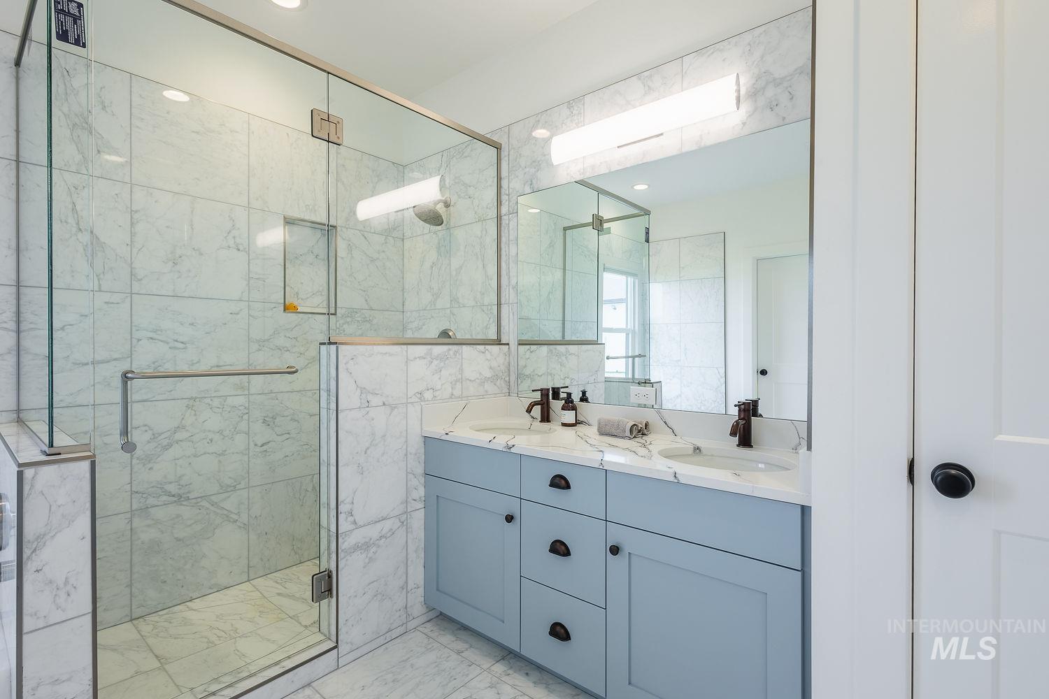11171 Pump Road Nampa, ID 83686 - Photo 20 of 50 Bathroom featuring a spacious walk-in shower with glass enclosure, white tiled walls, and a recessed shower niche