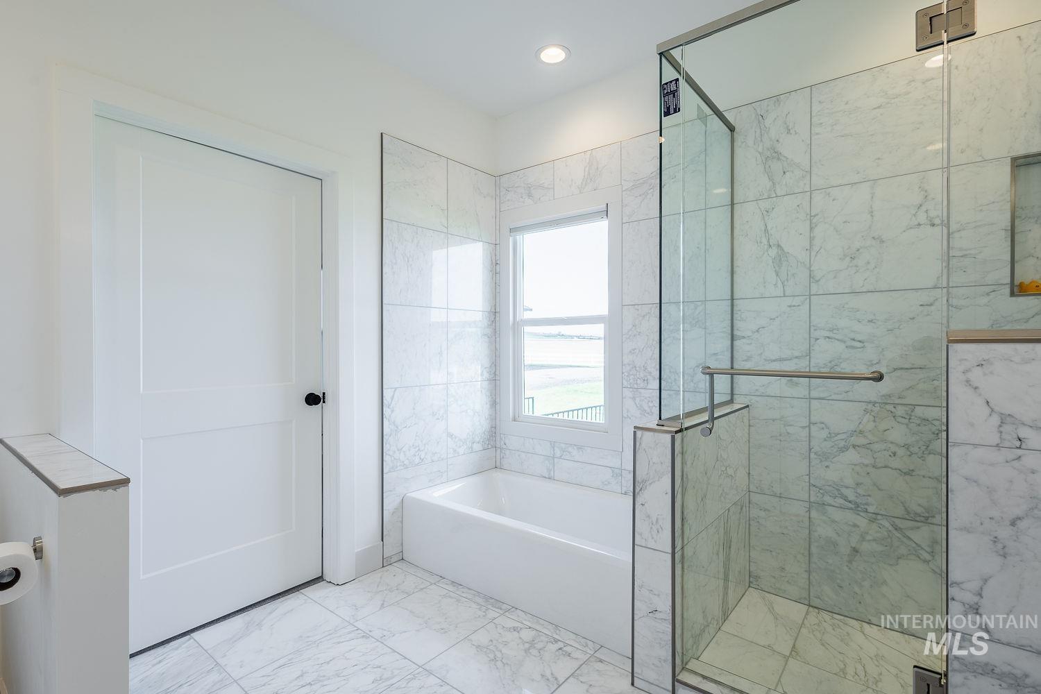 11171 Pump Road Nampa, ID 83686 - Photo 22 of 50 Bathroom featuring a walk-in shower with glass enclosure, a built-in bathtub, and marble-finish tile flooring