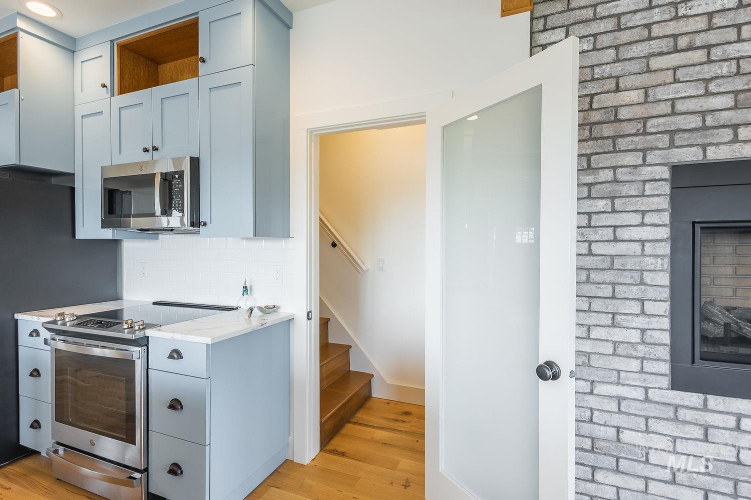 11171 Pump Road Nampa, ID 83686 - Photo 27 of 50 Kitchen area featuring light blue cabinetry, white subway tile backsplash, and stainless steel appliances