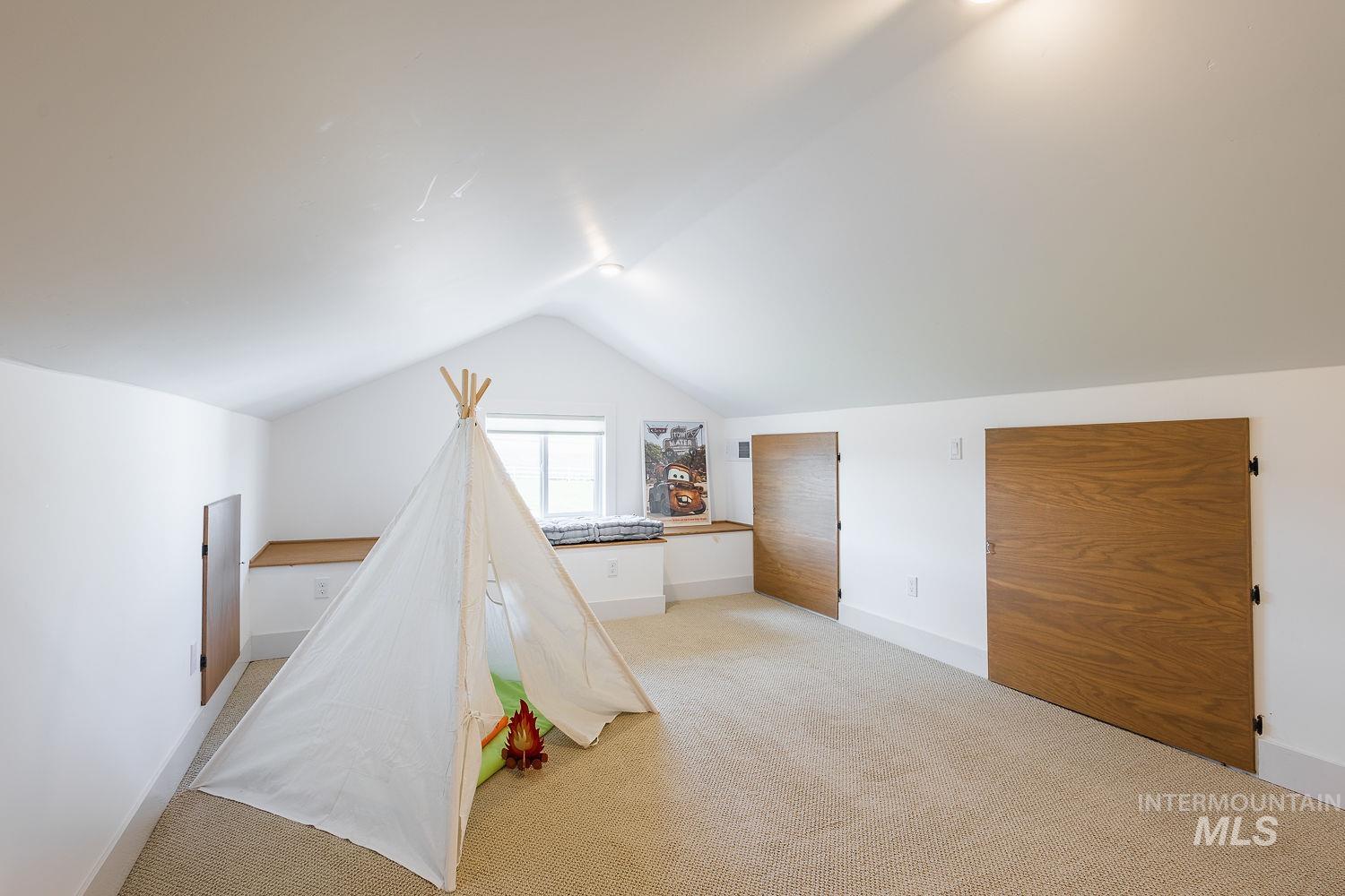 11171 Pump Road Nampa, ID 83686 - Photo 28 of 50 Carpeted attic space featuring white walls and a vaulted ceiling