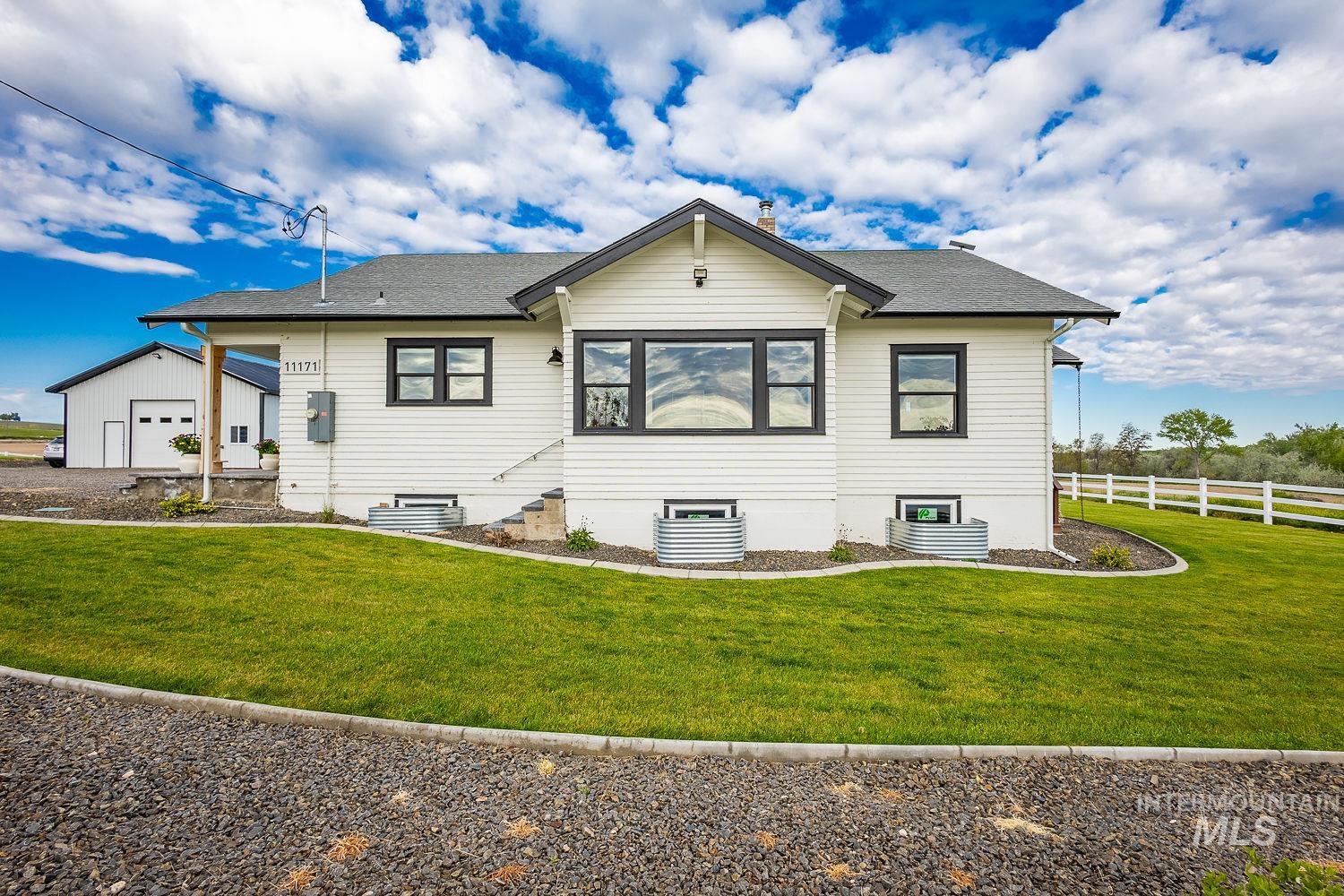 11171 Pump Road Nampa, ID 83686 - Photo 3 of 50 White siding exterior with dark-trimmed windows