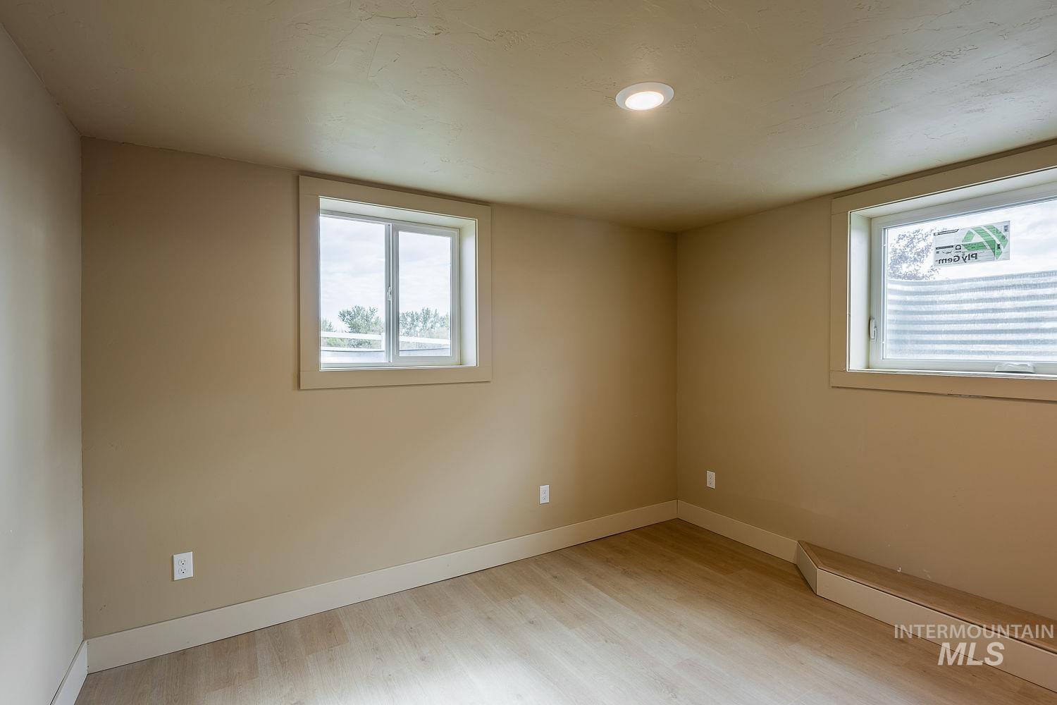 11171 Pump Road Nampa, ID 83686 - Photo 43 of 50 Room featuring two windows, wood-finish flooring, recessed lighting, and neutral wall tones