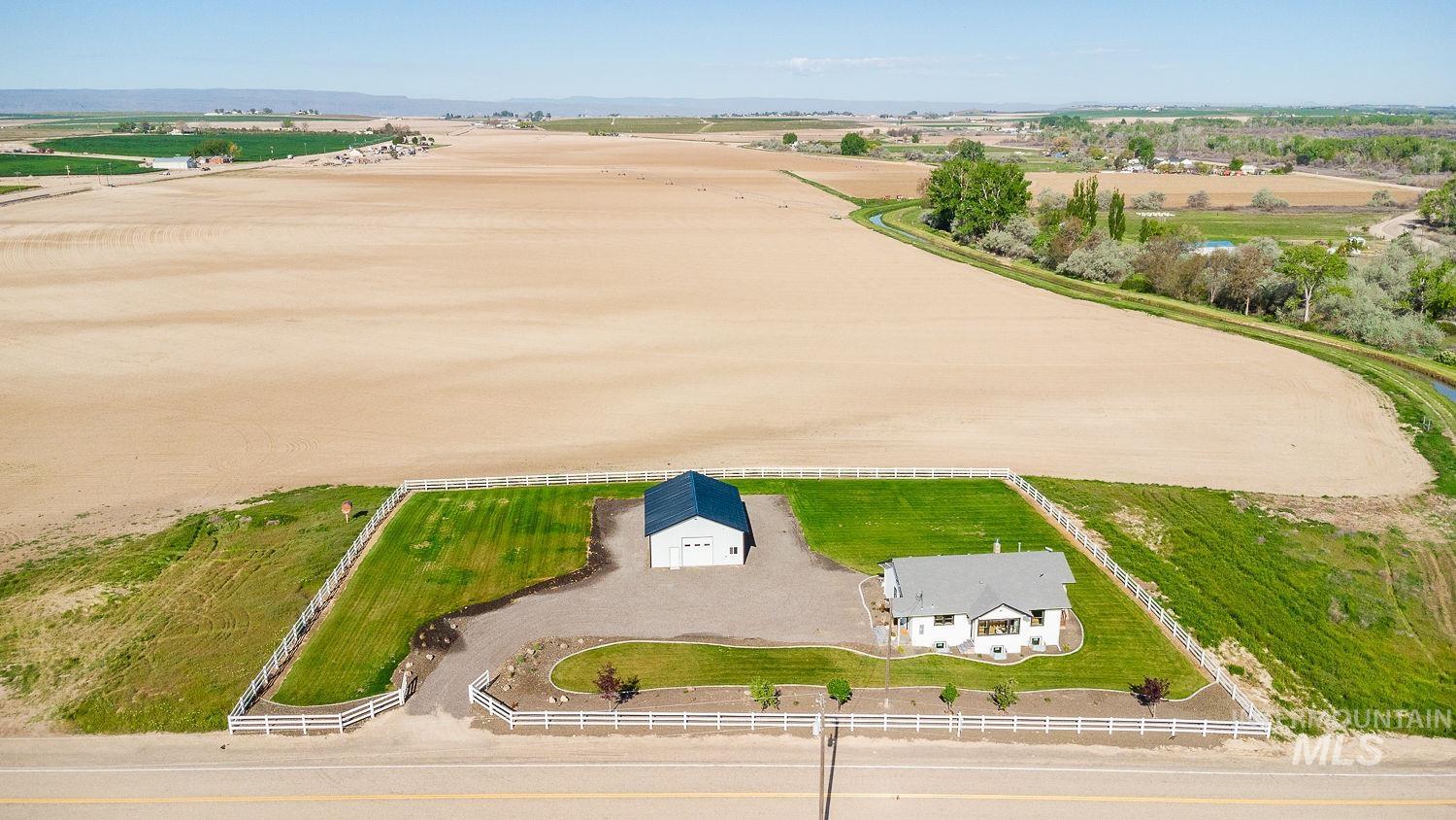 11171 Pump Road Nampa, ID 83686 - Photo 49 of 50 Aerial perspective highlighting a white residential structure with a gray roof