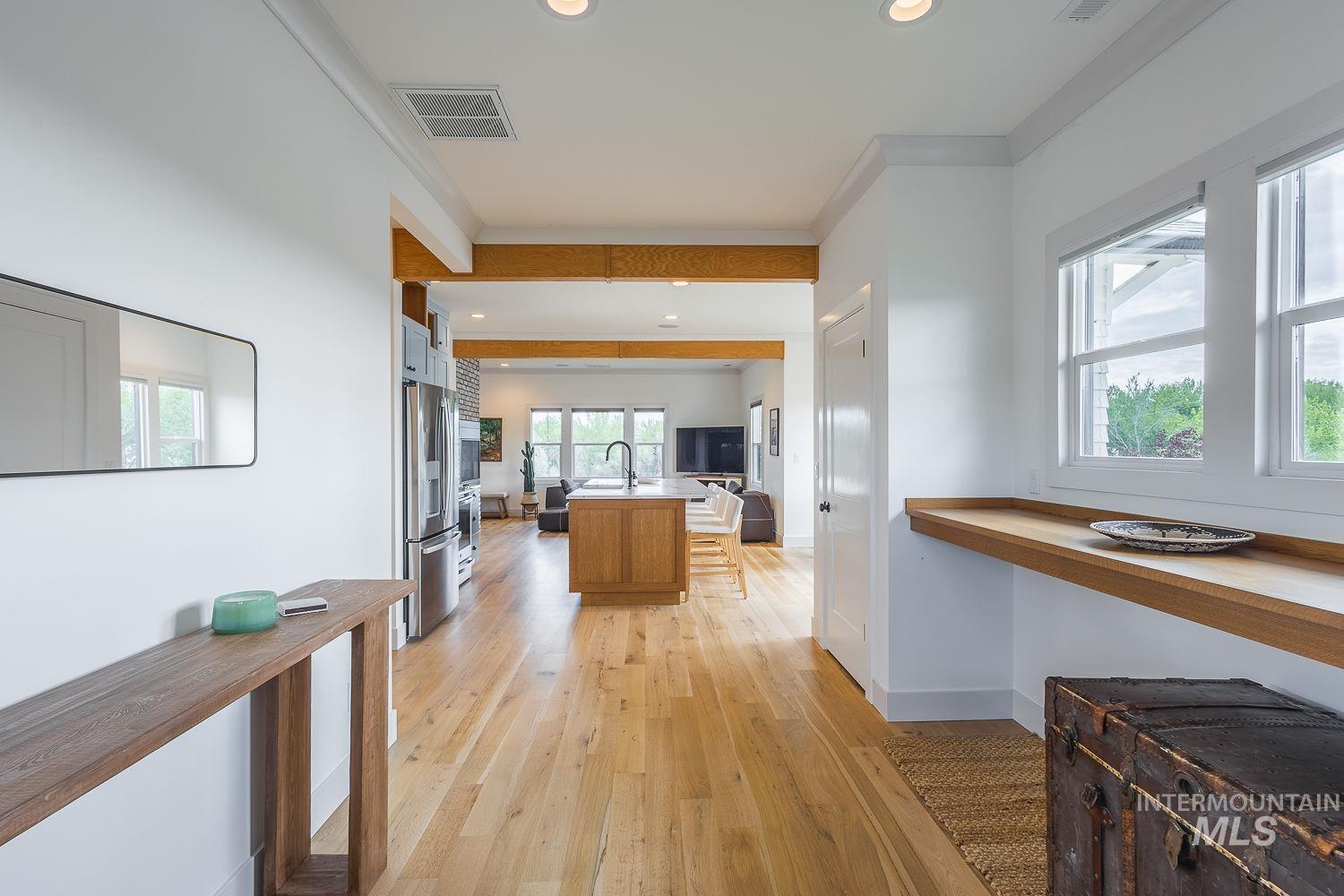 11171 Pump Road Nampa, ID 83686 - Photo 7 of 50 Open-concept interior featuring light wood-finish flooring, white walls, and exposed wood beams