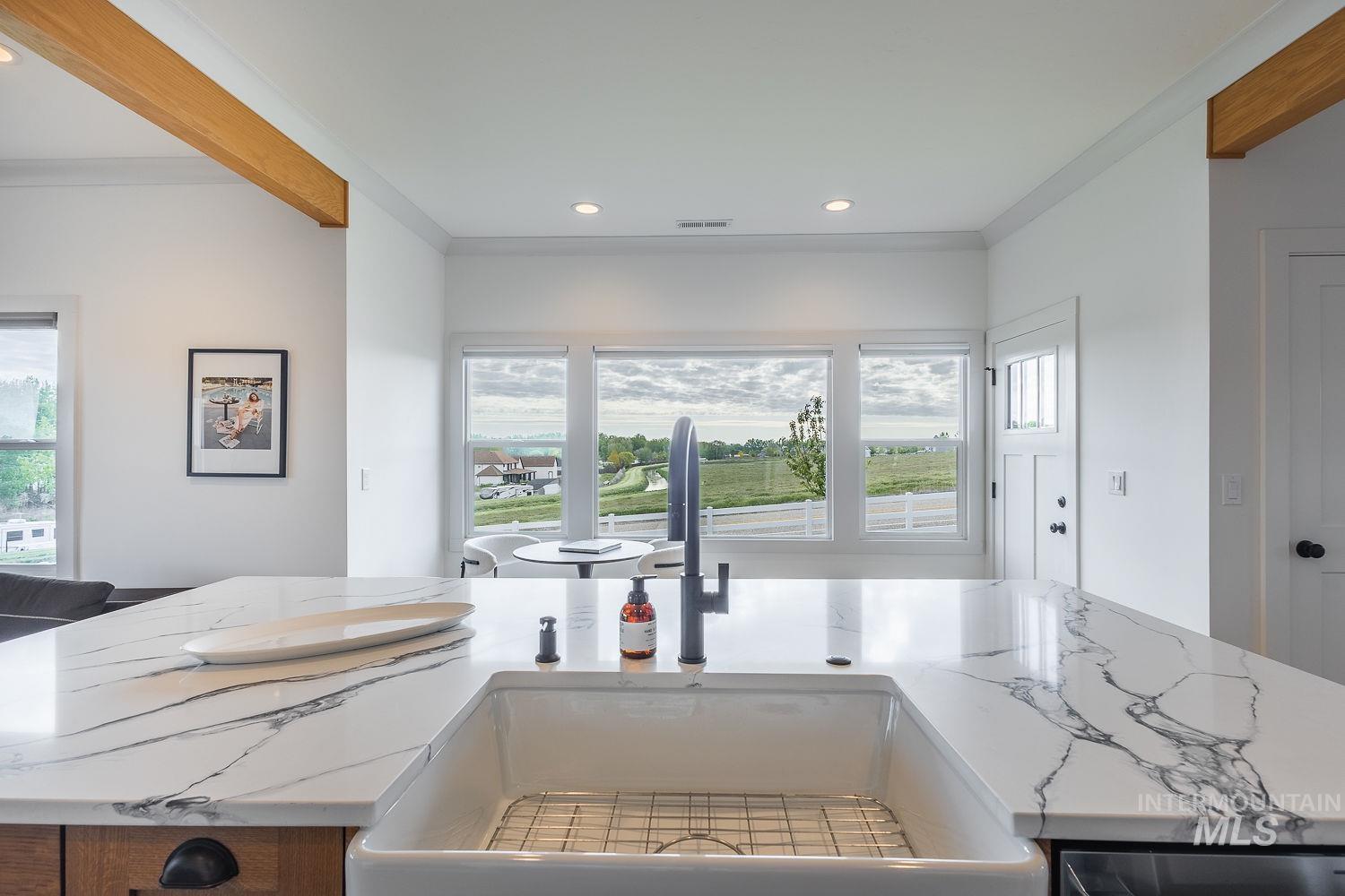11171 Pump Road Nampa, ID 83686 - Photo 10 of 50 Kitchen island with a white farmhouse sink and matte black faucet