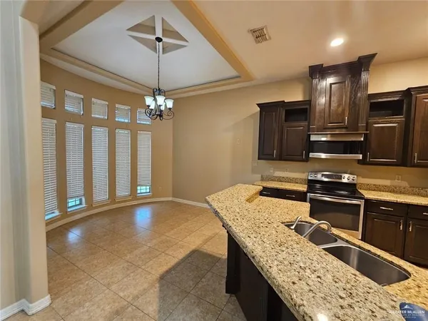 a kitchen with stainless steel appliances a refrigerator and a stove