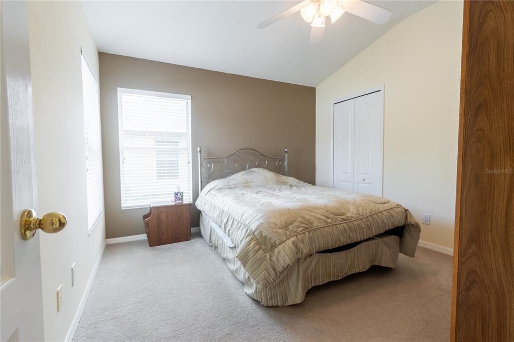 1812 Flower Branch Way Valrico, FL 33594 - Photo 30 of 42 a bedroom with a bed and a chandelier