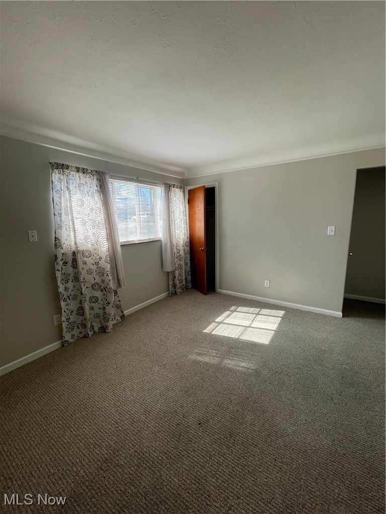 19860 Lorain Road, Unit 1 Cleveland, OH 44126 - Photo 2 of 8 Carpeted empty room featuring baseboards