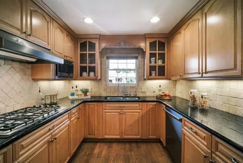 a kitchen with stainless steel appliances a sink stove and cabinets