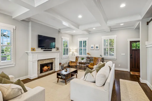 a living room with furniture a fireplace and a flat screen tv