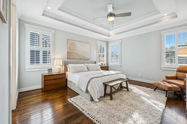 a bedroom with a bed a couch and chandelier