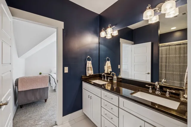 a en suite bathroom with double vanity and a mirror