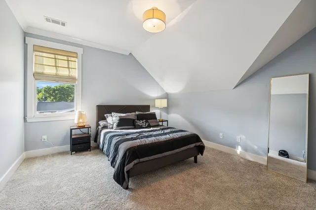 a bedroom with a bed and window