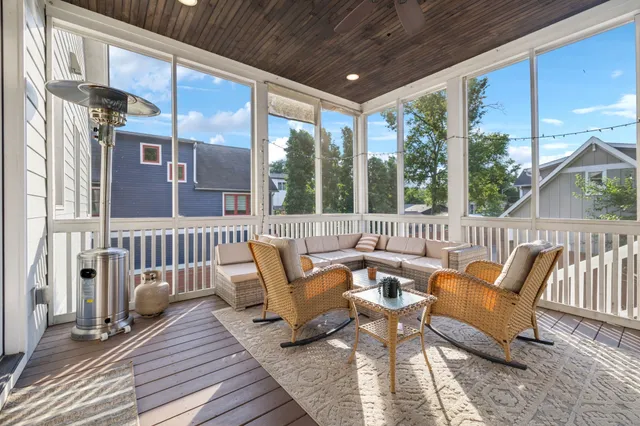 a roof deck with a table and chairs