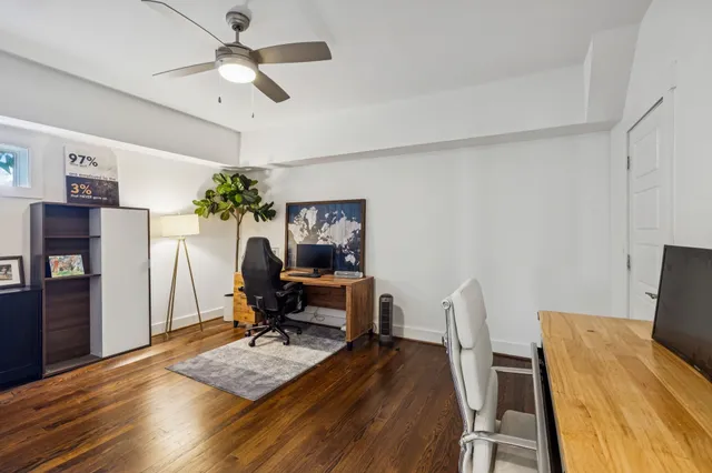a view of a workspace with furniture and wooden floor
