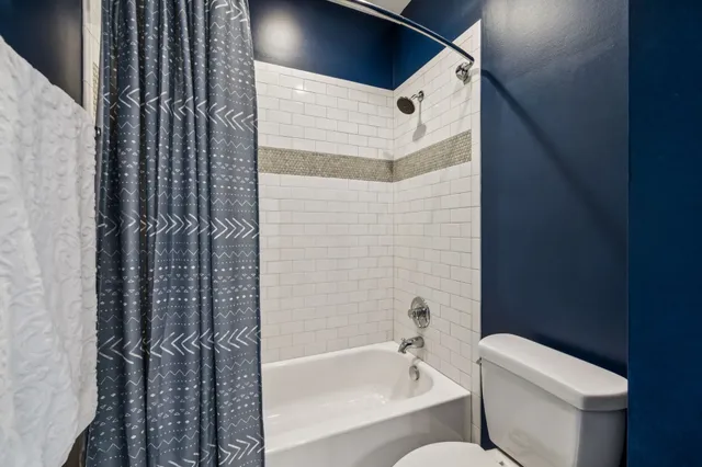 a bathroom with a toilet and a bathtub