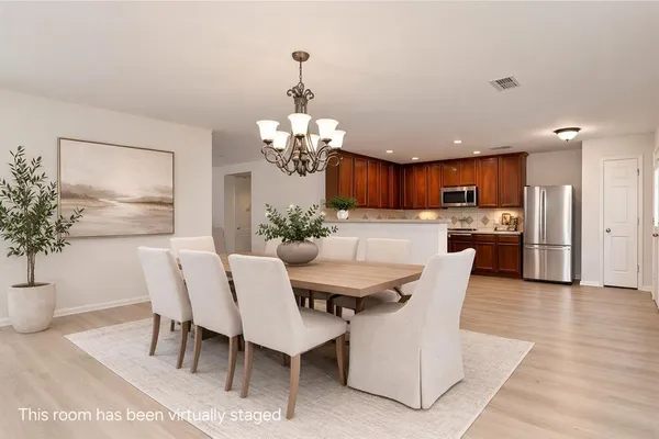 a view of a dining room with furniture and chandelier