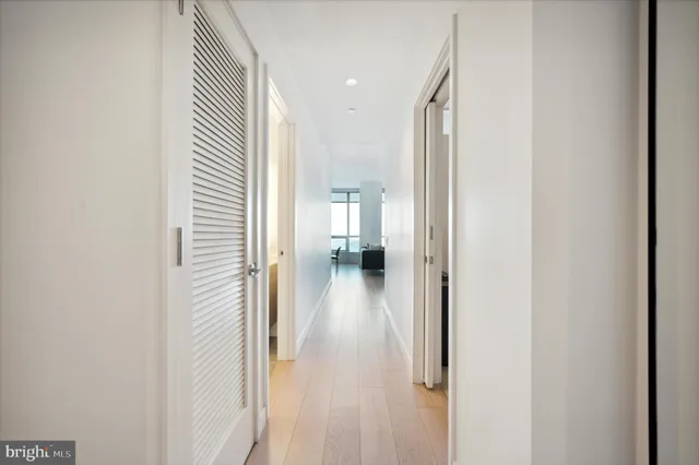 a view of a hallway with wooden floor
