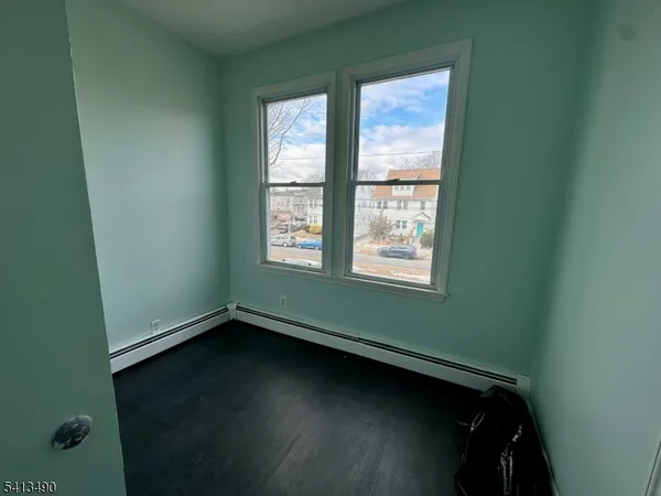 a view of room with window and hardwood floor